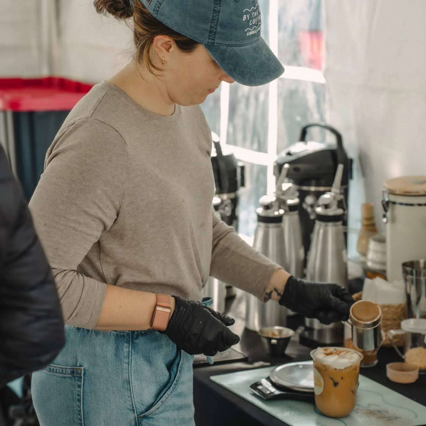 A coffee professional preparing drinks behind the bar